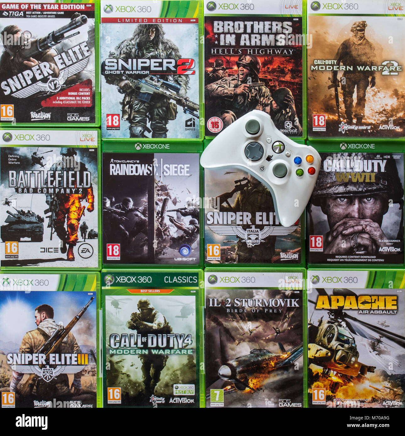 Controller and collection of violent first-person shooter video games for Xbox 360 and Xbox One Stock Photo