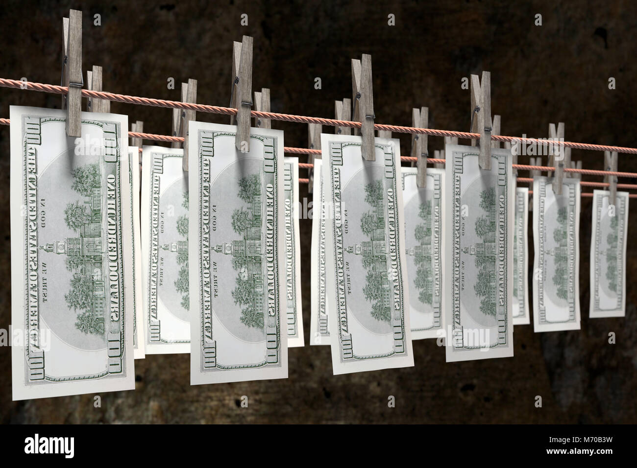 3D render of one hundred dollar banknotes hanging on laundry line attached with wooden clothes pegs against dark brown wall Stock Photo