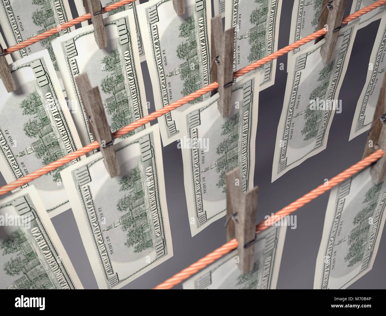 3D render of one hundred dollar banknotes hanging on laundry line attached with wooden clothes pegs shot from above Stock Photo