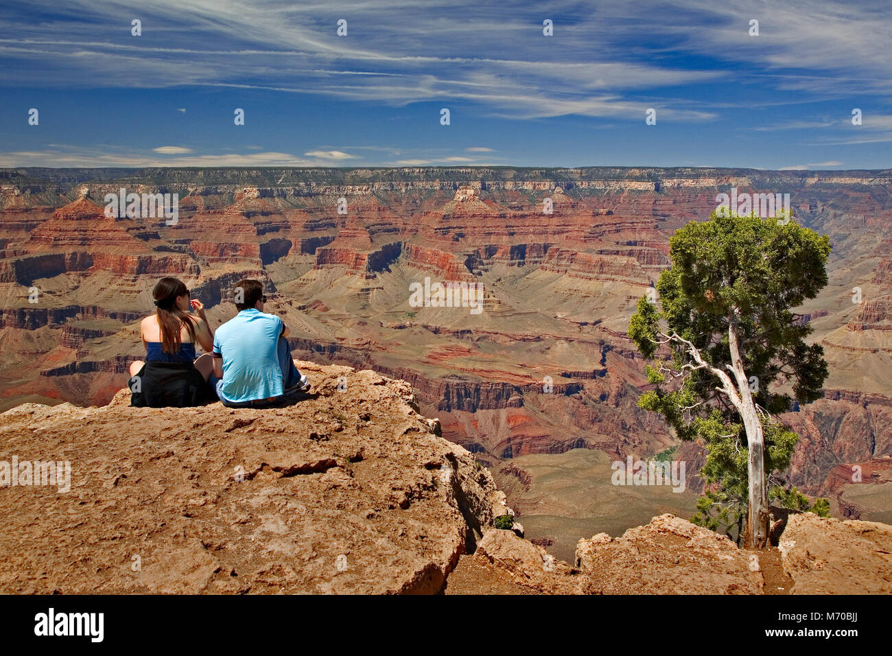 Couple on the south rim of the Grand canyon Stock Photo