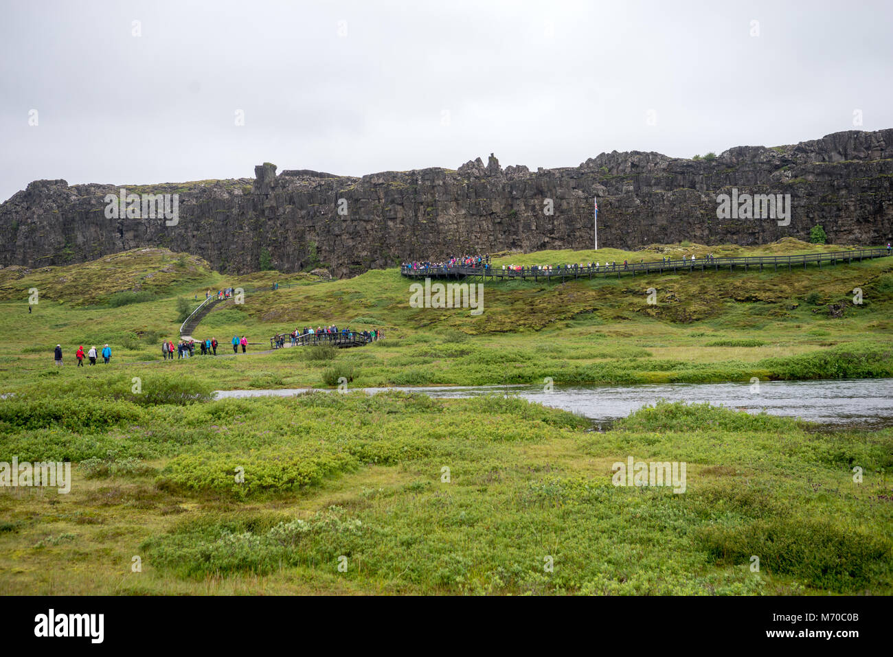 Thingvellir, Iceland - July 19, 2017: Tourists walk through the Almannagja fault line in the mid-atlantic ridge north american plate in Thingvellir Na Stock Photo