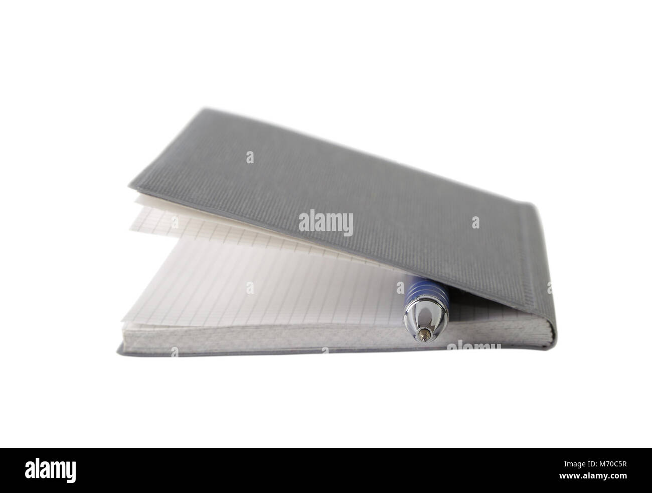 Notepad with pen isolated on white closeup Stock Photo - Alamy