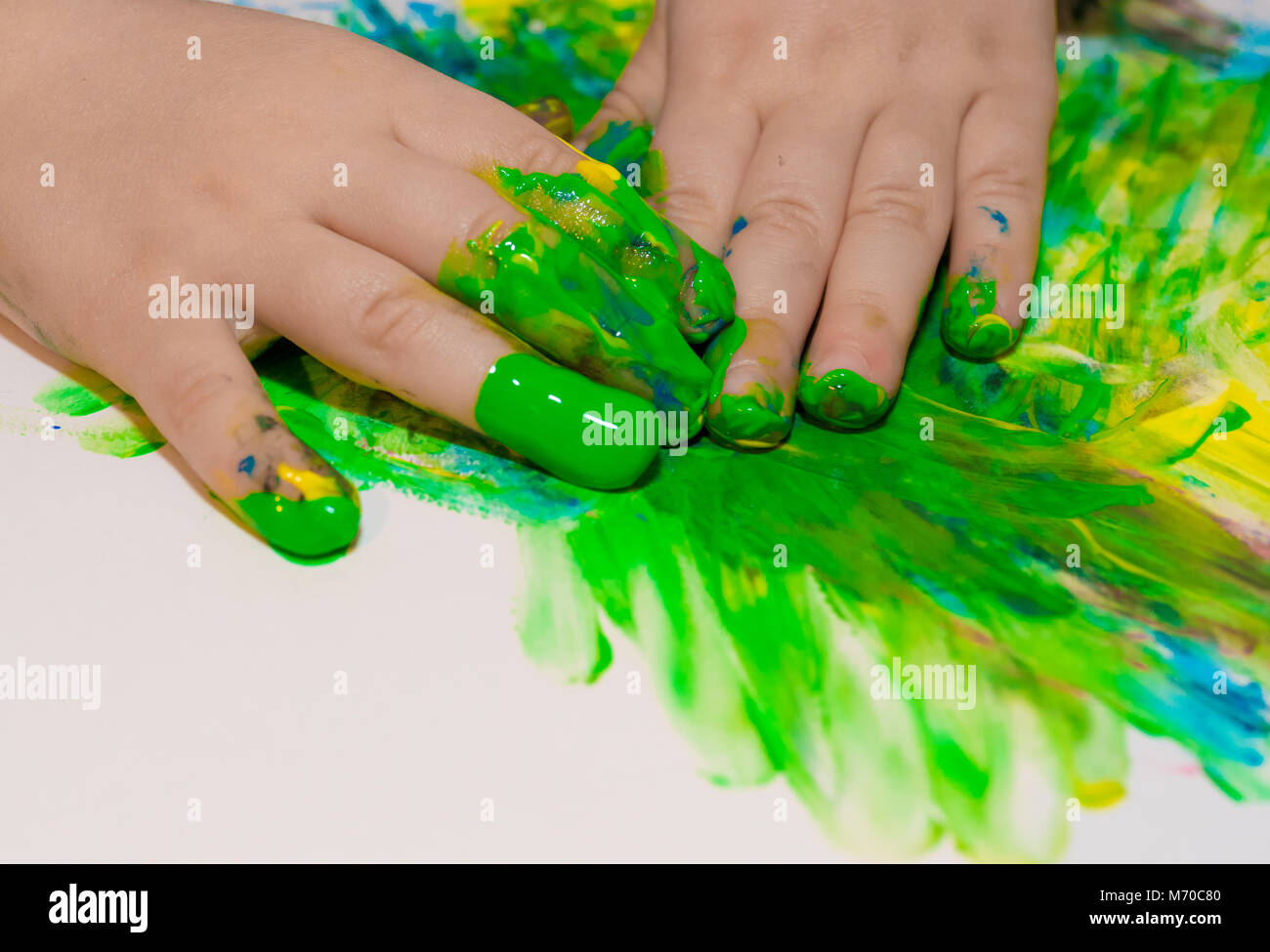 Child hands painted in colorful paints. Education, school, creativity and painting concept. Soft focus an blurry Stock Photo