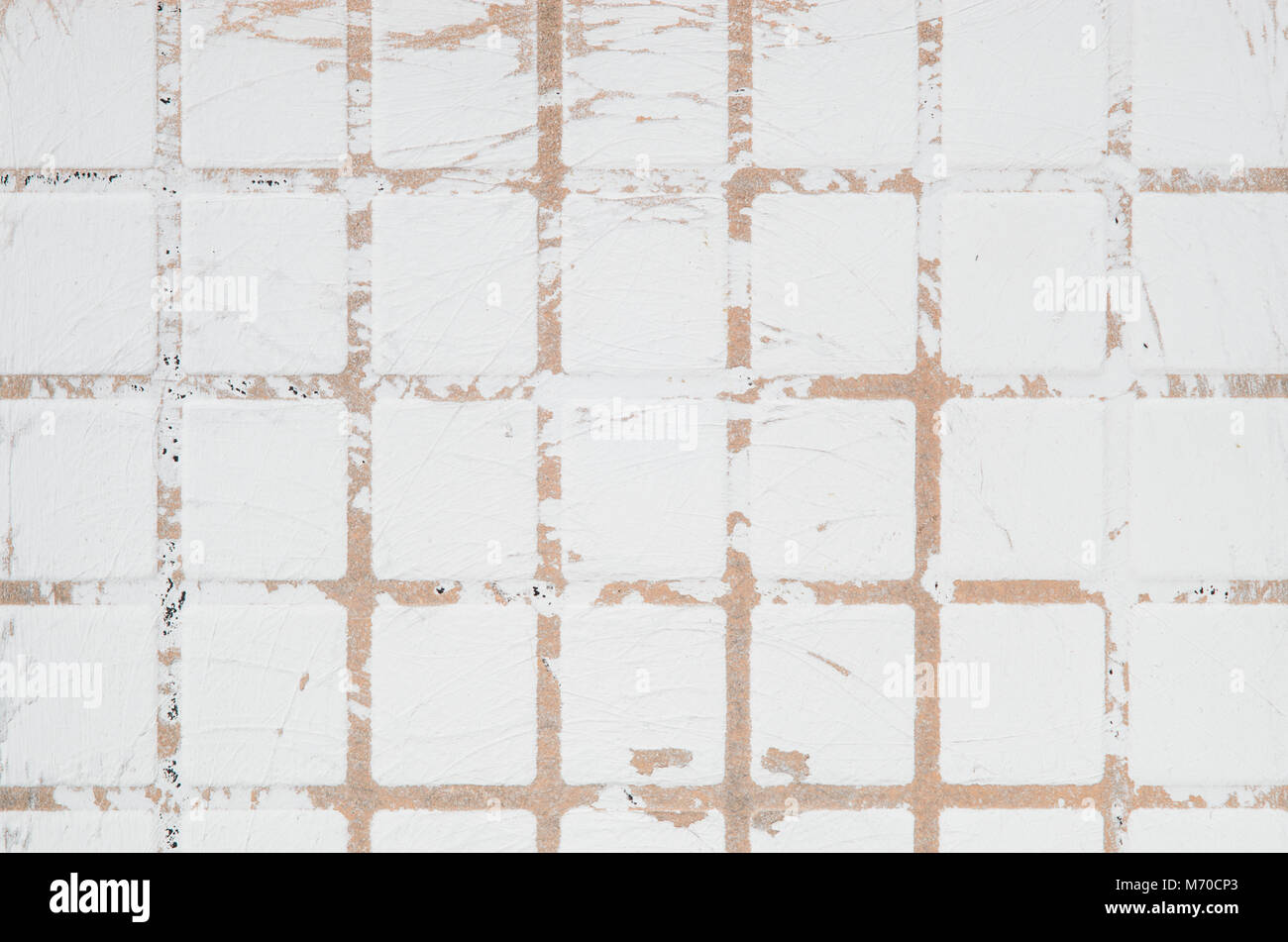 Texture of ceramic scratched tile with checkered embossing. White scratched wall background