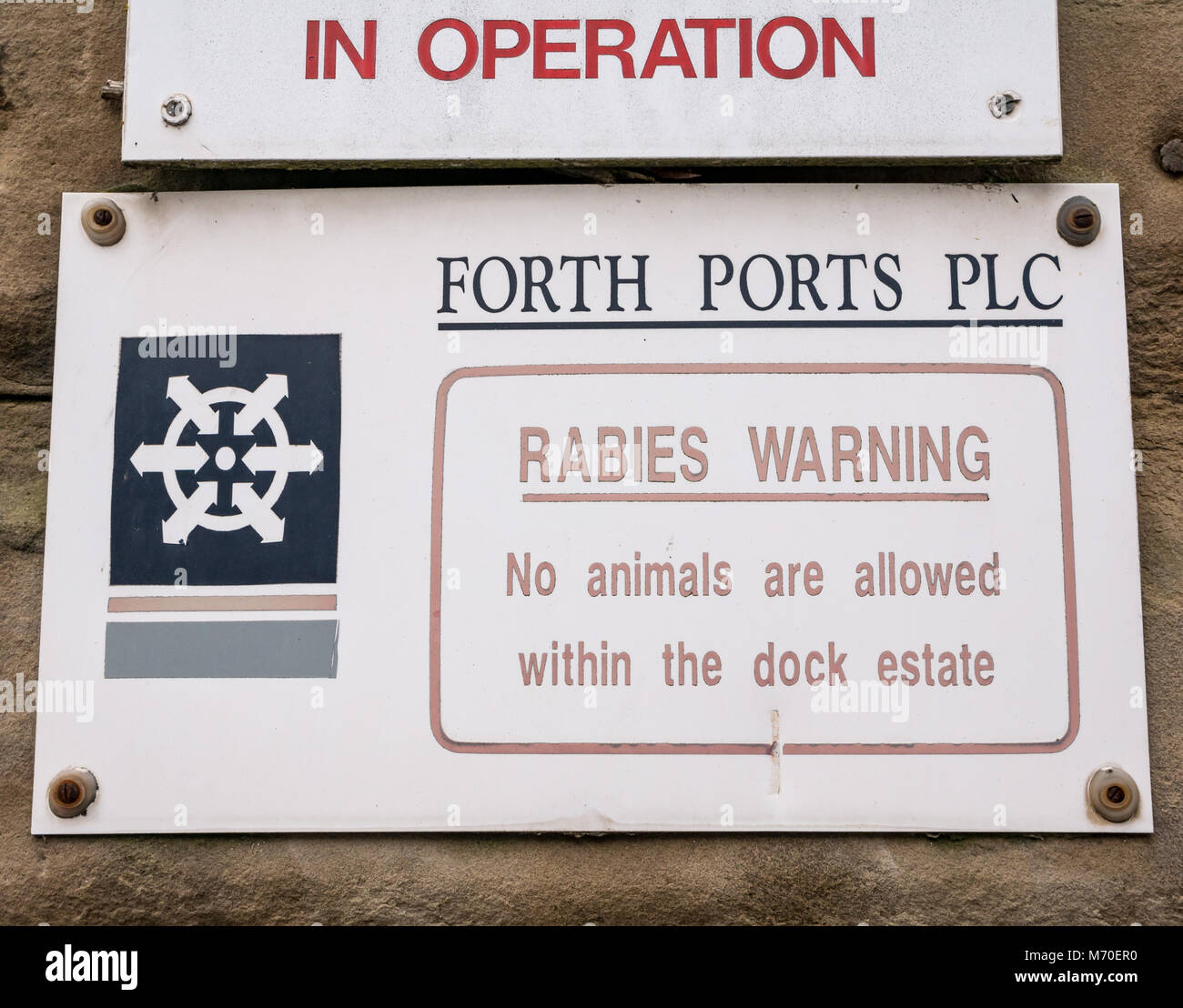 Close up of Forth Ports entrance sign warning about rabies, Leith Dock, Edinburgh, Scotland, UK Stock Photo