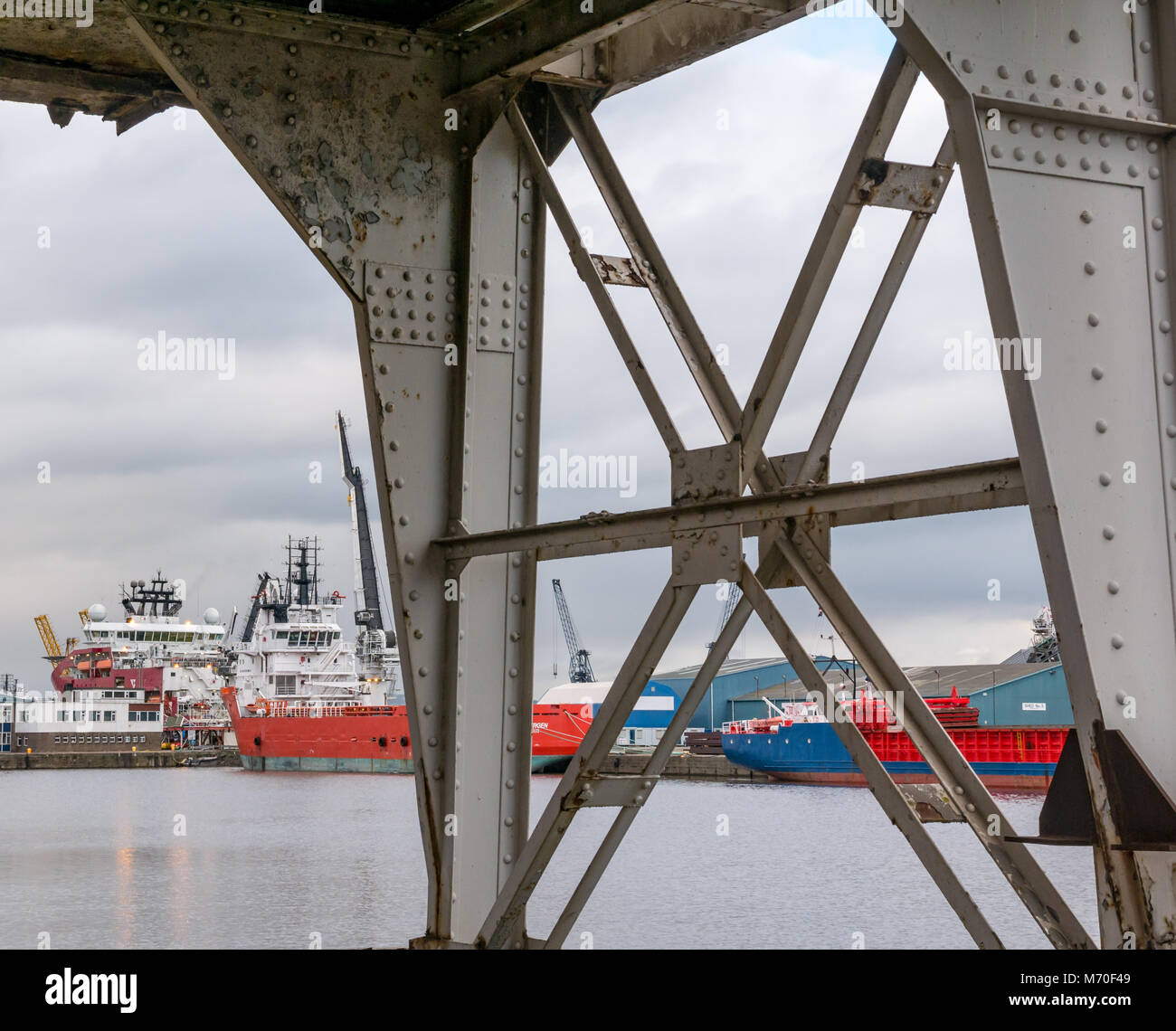 Looking through old Stothert and Pitt disused cranes to supply ships moored in port, Leith Dock, Edinburgh, Scotland, UK Stock Photo