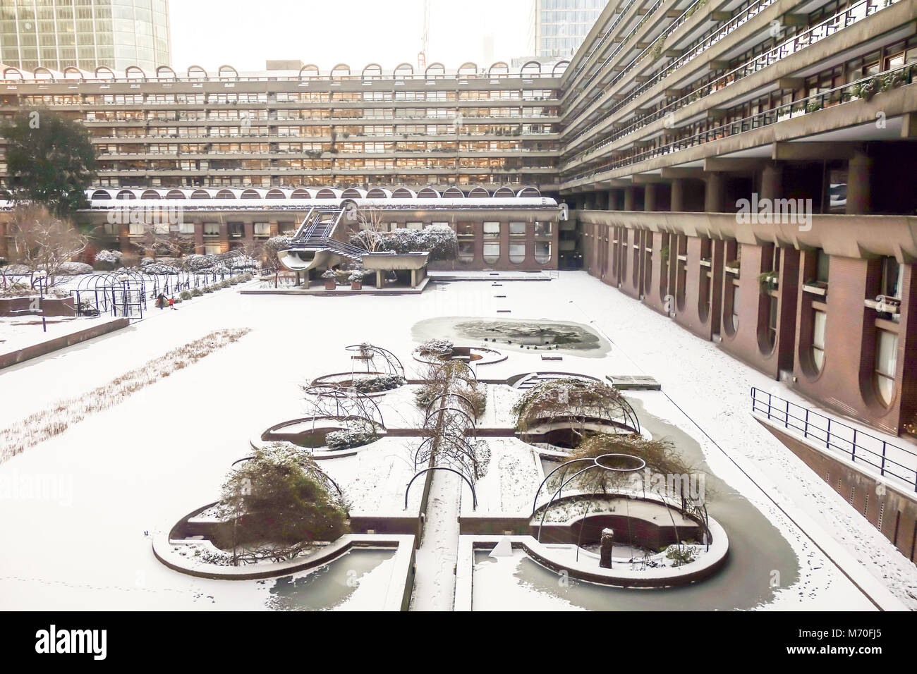 LONDON, UK -28th Feb 2018: Heavy snow falls across the Barbican lake caused by snow storm Emma. Stock Photo