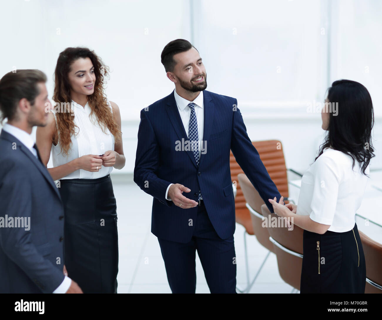 business team talking, standing in office Stock Photo - Alamy