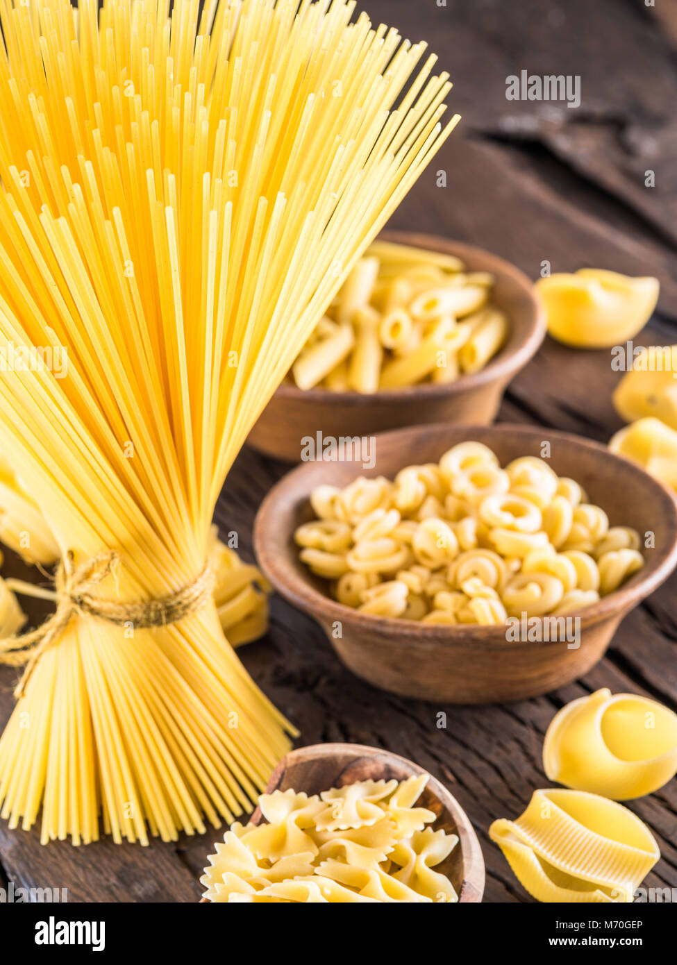 Different pasta types on wooden table. Stock Photo