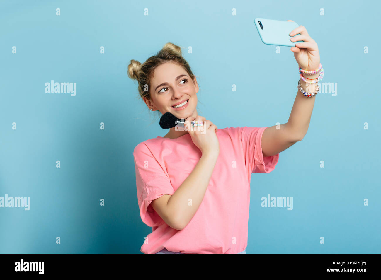 trendy woman - making selfie at blue background Stock Photo