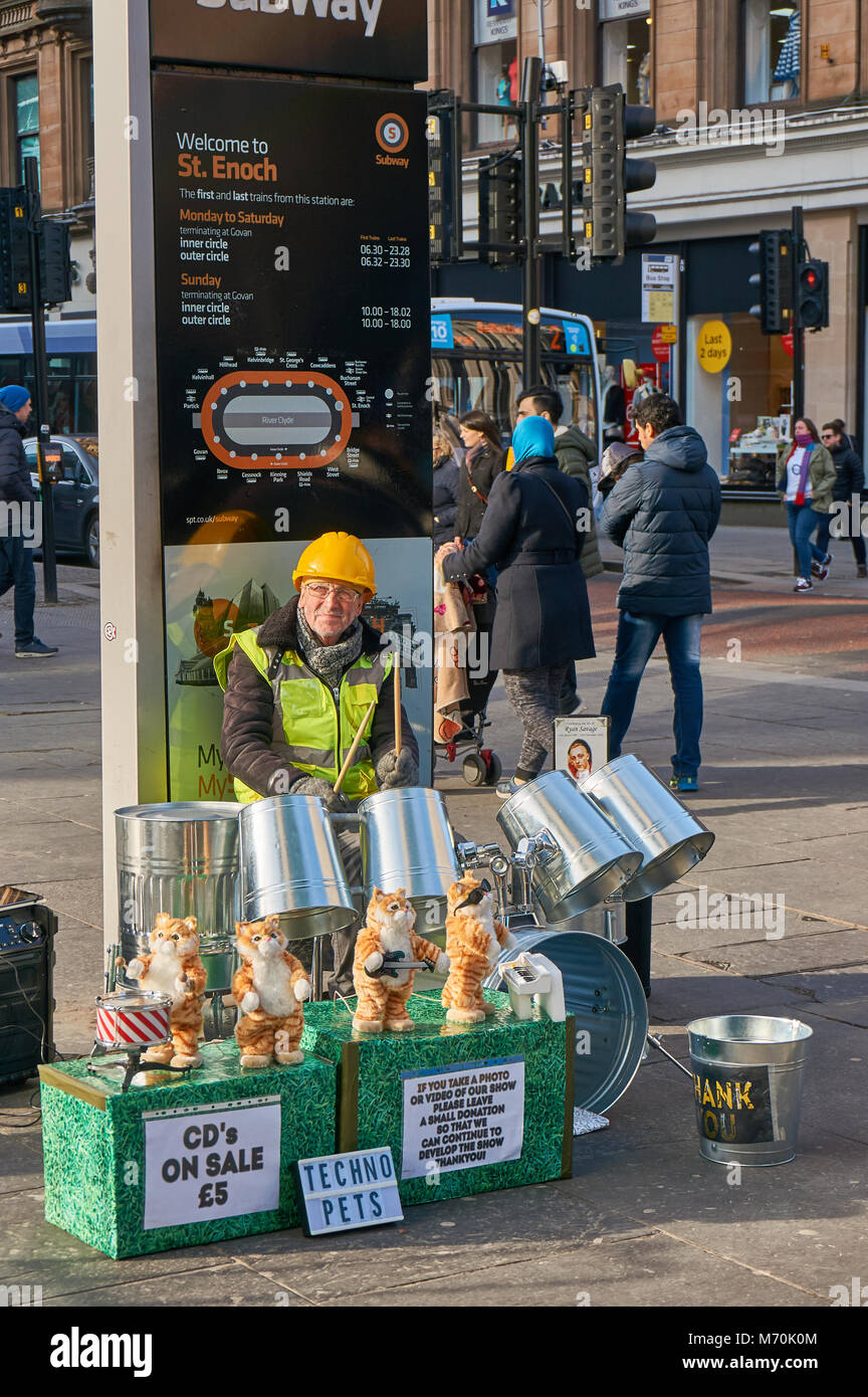 Street artist playing bin drums on the streets of Glasgow, UK Stock Photo