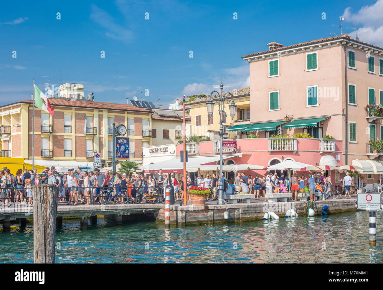 People queue at the pier at Sirmione Lake Garda in the Italian Lakes Stock Photo