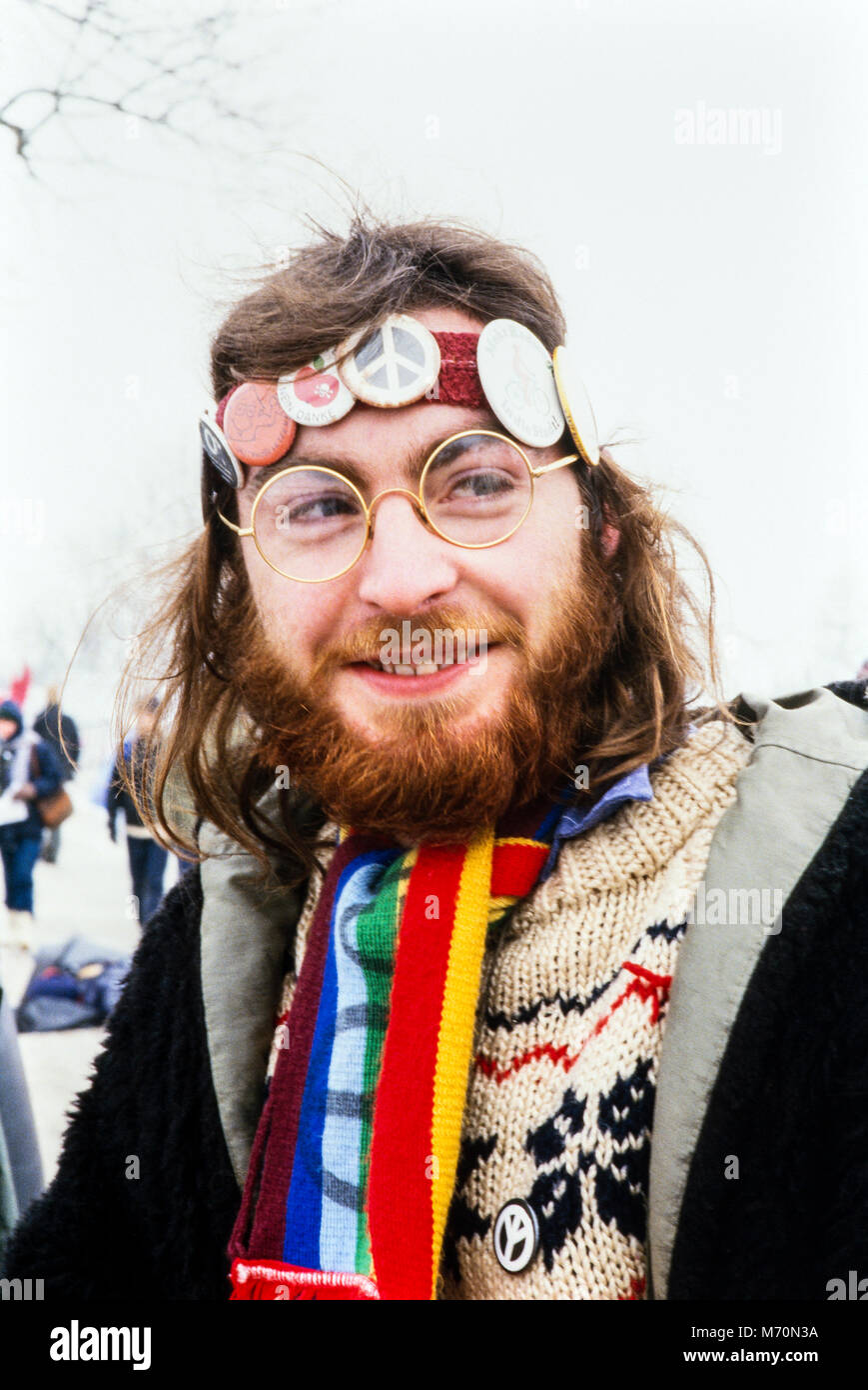 Bearded long haired man wearing headband with anti nuclear badges at the Anti cruise missile demonstration at the Molesworth missile base on 2nd February 1986 in snowy conditions. Cambridgeshire, England, UK, archival photograph, Stock Photo