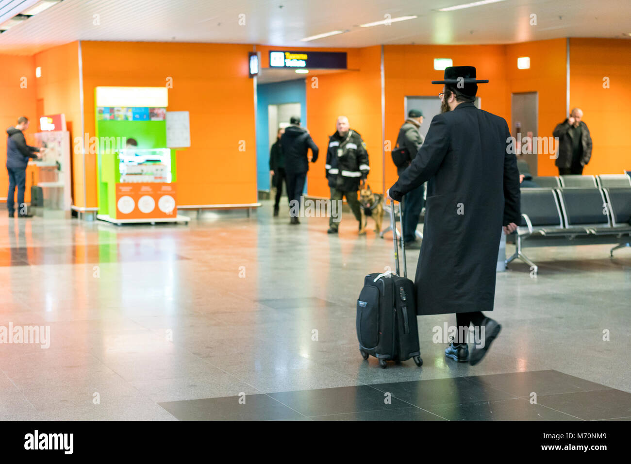 Jew orthodox with a suitcase is going around the airport. Stock Photo