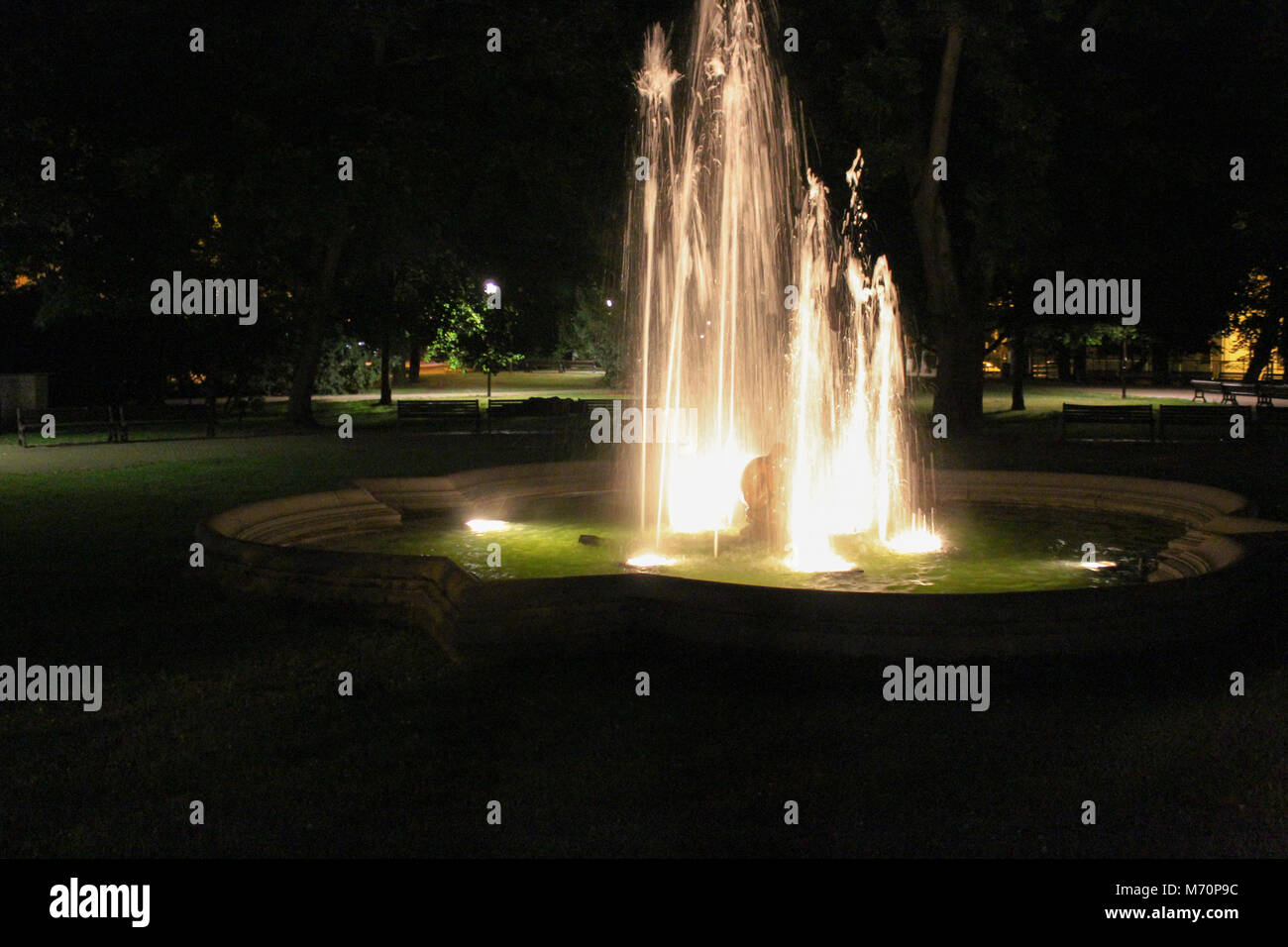 Fountain in night with statue in the middle with park Stock Photo - Alamy