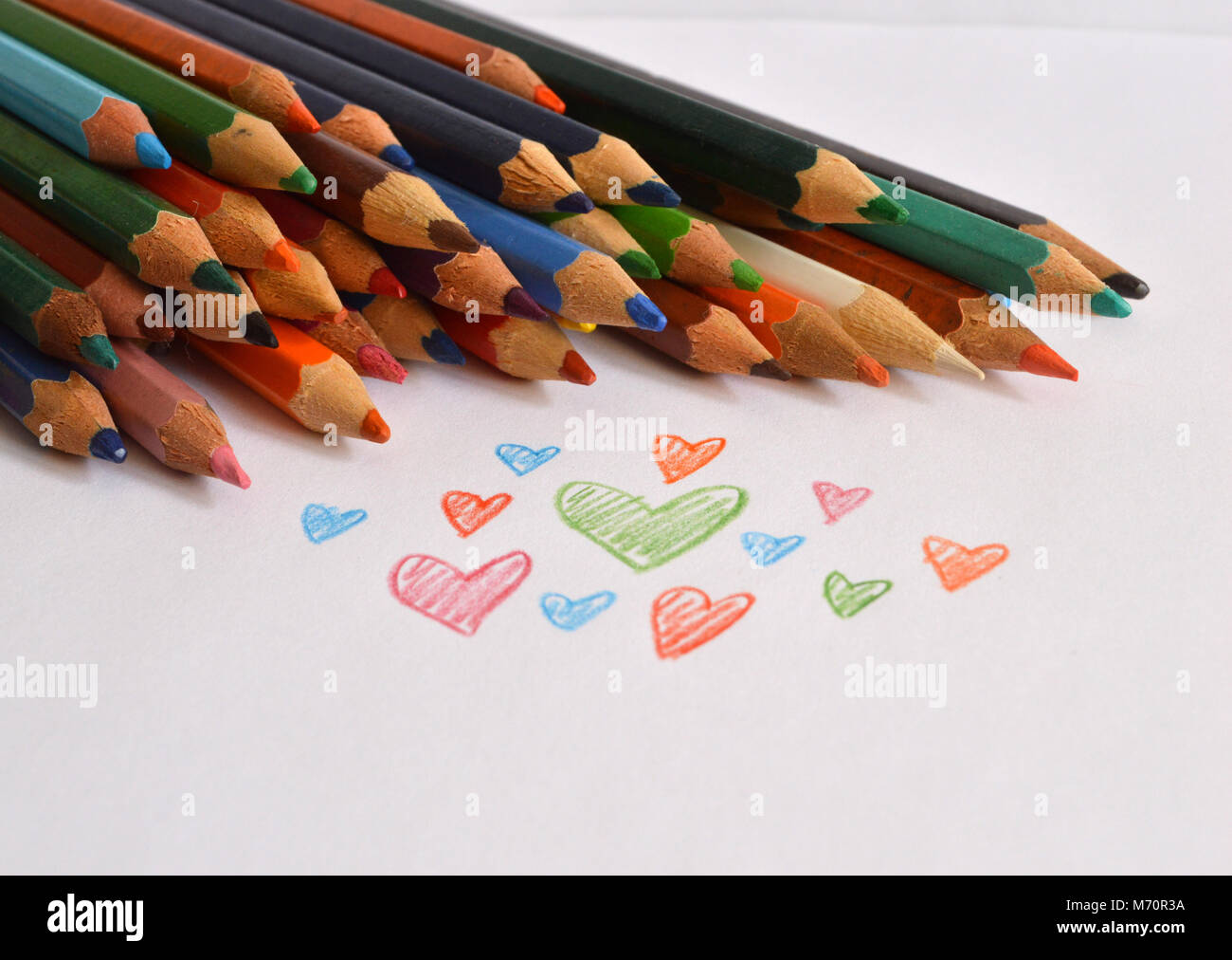 Stacked colored pencils with hearts drawing Stock Photo Alamy