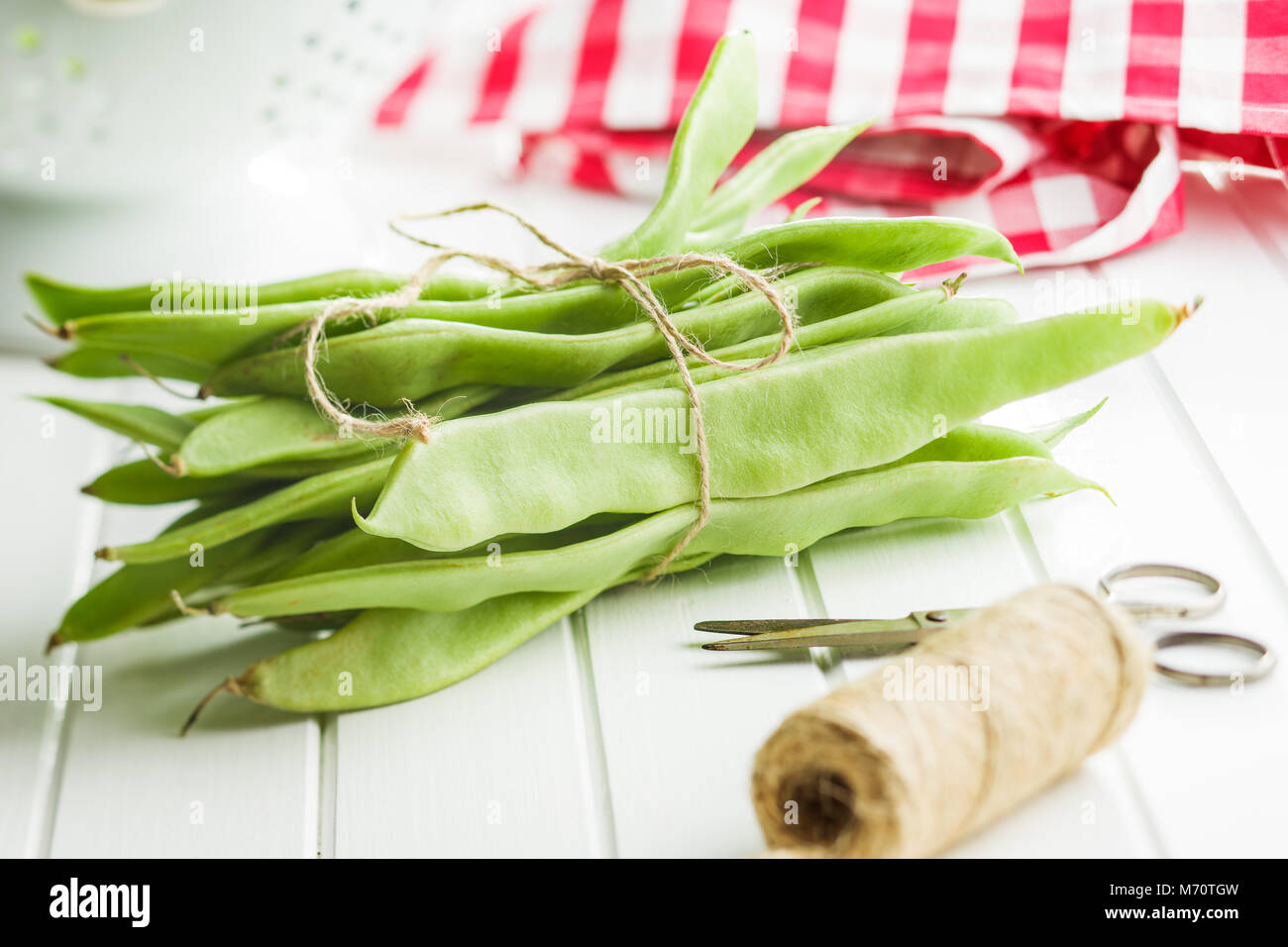 Green string beans pods on white table. Stock Photo