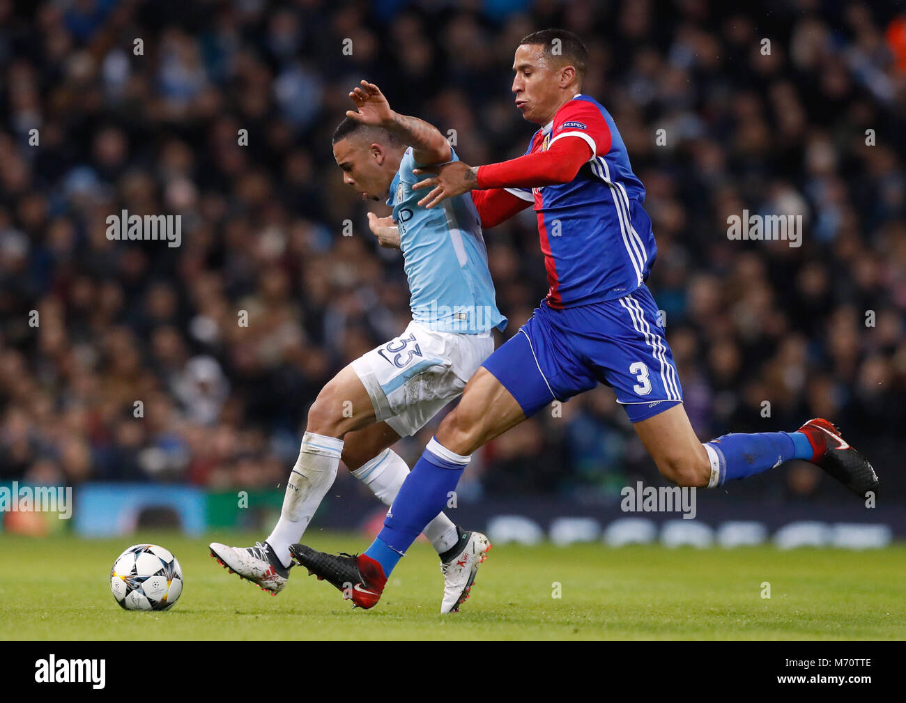 Manchester City's Gabriel Jesus (left) and FC Basel's Leo Lacroix battle for the ball during the UEFA Champions League round of 16, second leg match at the Etihad Stadium, Manchester. Stock Photo