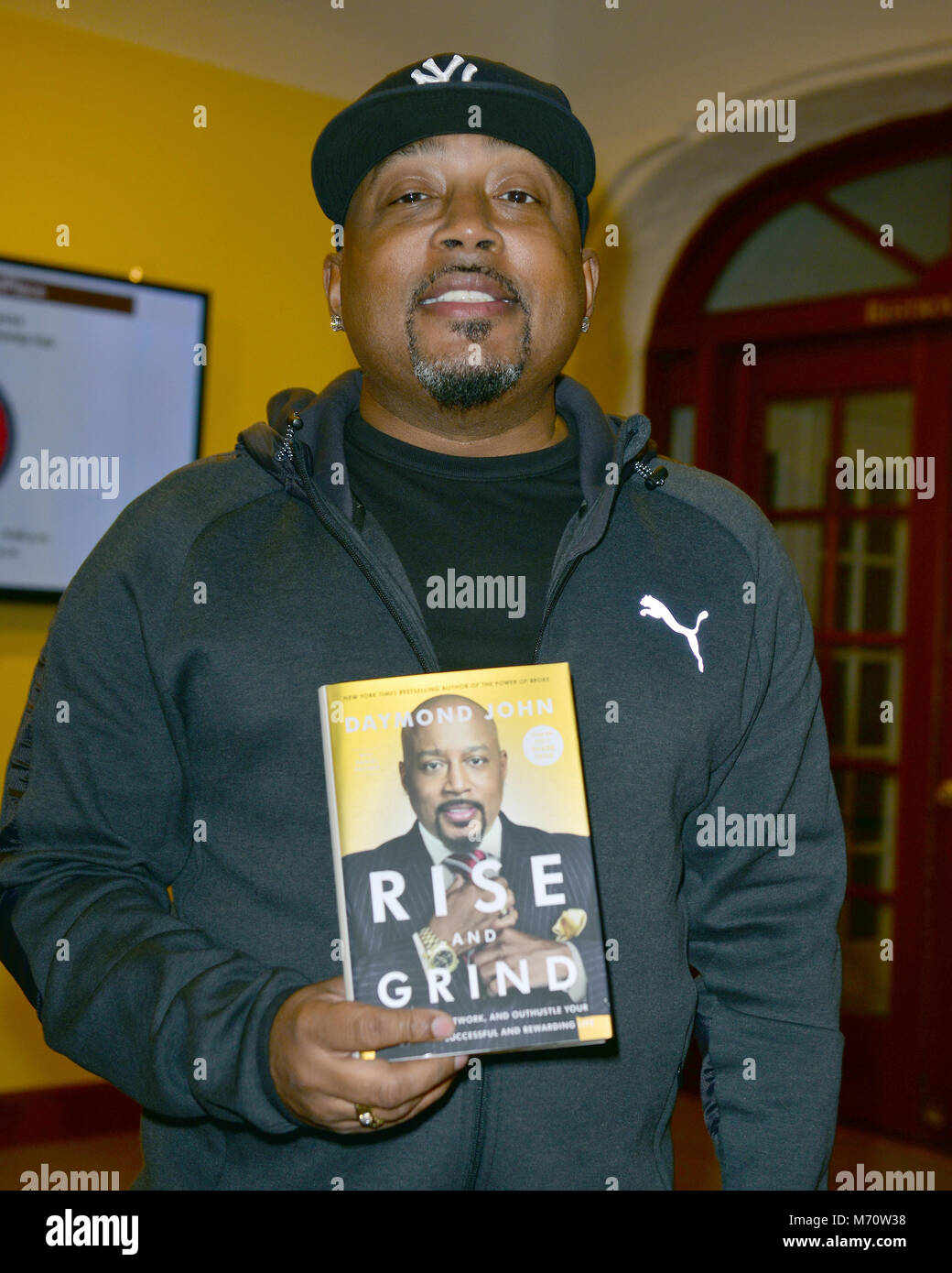 Daymond John signs copies of his new book 'Rise and Grind Outperform