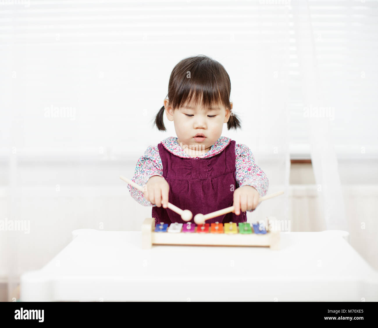 baby girl play xylophone at home Stock Photo Alamy