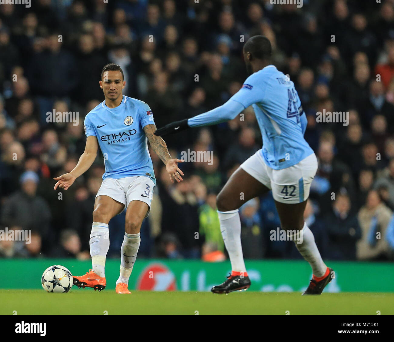 Manchester, UK. 7th March 2018 , Champions League Round of 16 leg 2, Manchester City versus FC Basel; Danilo #3 of Manchester City lays the ball on for Yaya Toure #42 of Manchester City Stock Photo