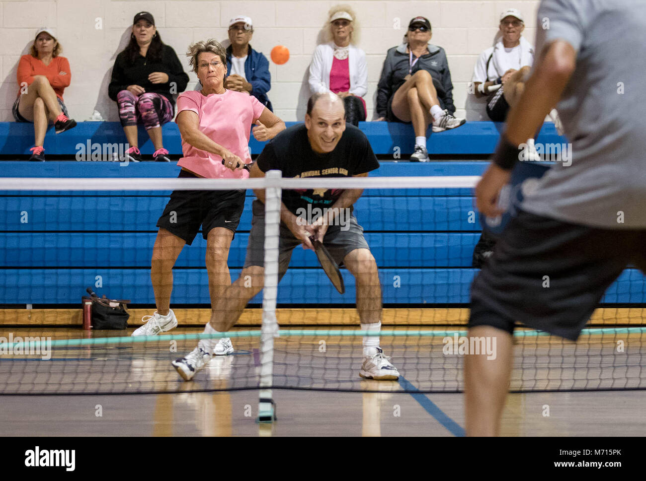 Delray Beach, Florida, USA. 7th Mar, 2018. Pam Garcia, Boynton Beach, returns a shot over her partner, Julian Gershaw, Delray Beach, during the Gold Medal pickleball match (60-64) in mixed doubles at the 29th Annual Delray Beach Senior Games at Pompey Park in Delray Beach, Florida on March 7, 2018. Garcia and Gershaw won Silver medals falling in a tiebreaker match to Masi Jacobs, Jensen Beach, and Sheridan Collins, Stuart. Nearly 200 seniors participated in the week long games that included track and field, bowling, powerlifting, swimming, golf, croquet, billiards, basketball and archery. M Stock Photo
