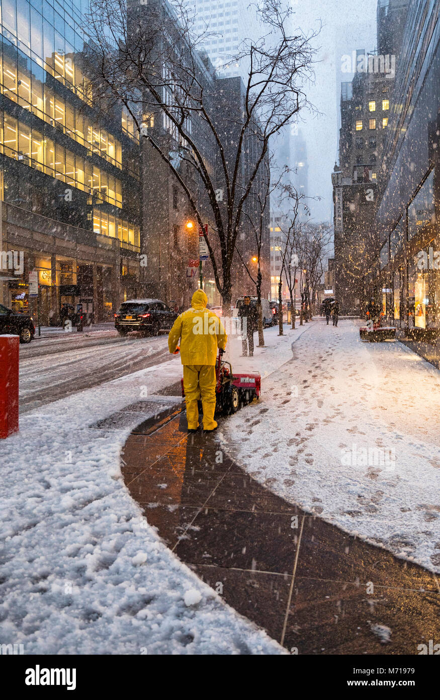 New York City, USA. 7th March, 2018. New York City; USA; Thursday March 7 2018; Snowfall in New York City; Worker clean snow with snow blower from sidewalk on 53 street Credit: Nino Marcutti/Alamy Live News Stock Photo