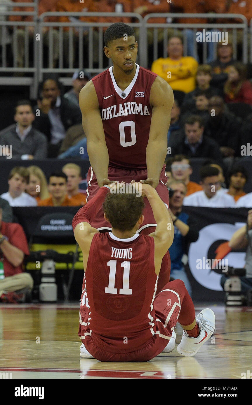 Kansas City, Missouri, USA. 07th Mar, 2018. Oklahoma Sooners guard Christian James (0) helps Oklahoma Sooners guard Trae Young (11) up from the floor during the 2018 Phillips 66 Big 12 Men's Basketball Championship game between the Oklahoma Sooners and the Oklahoma State Cowboys at the Sprint Center in Kansas City, Missouri. Kendall Shaw/CSM/Alamy Live News Stock Photo