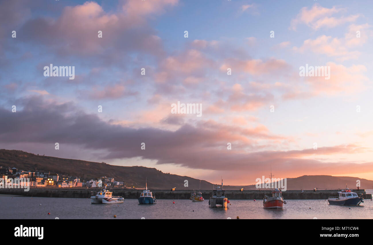 Lyme Regis, UK. 8th March, 2018. UK Weather: Early morning colours this morning in Lyme Regis (The Pearl of Dorset) contrast with the unprecedented  arctic conditions that hit the town and the South Coast  following Storm Emma last week and suggest warmer weather ahead and the arrival of spring. Credit: Celia McMahon/Alamy Live News Stock Photo
