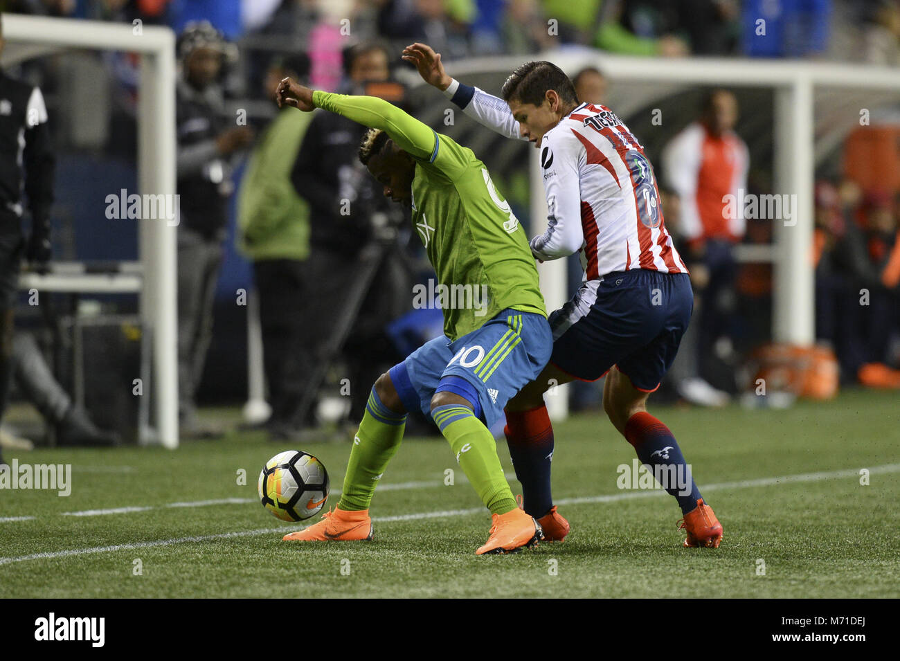 Seattle, Washington, USA. 7th Mar, 2018. CONCACAF Soccer 2018: JESUS GODINEZ (89) defends against WAYLON FRANCIS (90) as Chivas Guadalajara visits the Seattle Sounders in a CONCACAF quarterfinal match at Century Link Field in Seattle, WA. Seattle won the match 1-0. Credit: Jeff Halstead/ZUMA Wire/Alamy Live News Stock Photo