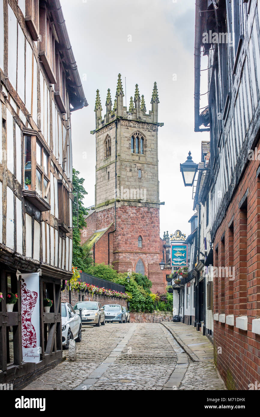View along the cobbled Fish Street in Shrewsbury with pub and church in