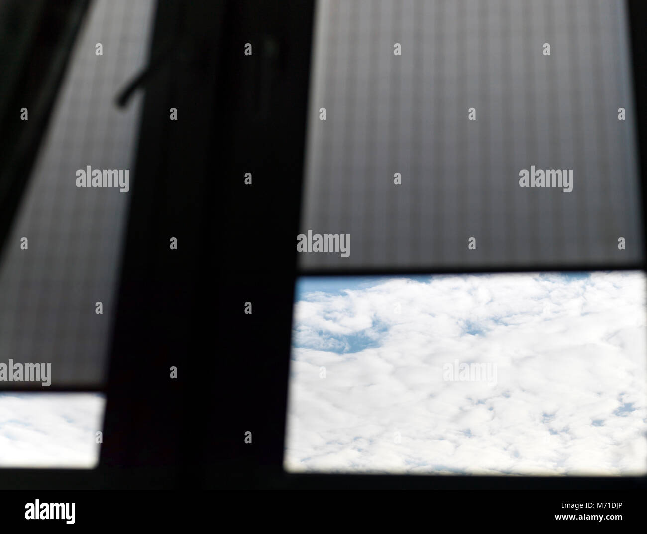 Piece of the cloudy sky through the window, cropped low angle shot ...