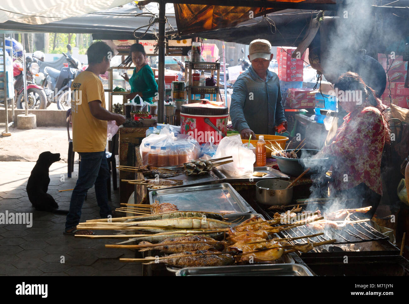 Stallholder cooking fish on the grill, Kep Crab market, Kep, Kampot province, Cambodia Asia Stock Photo
