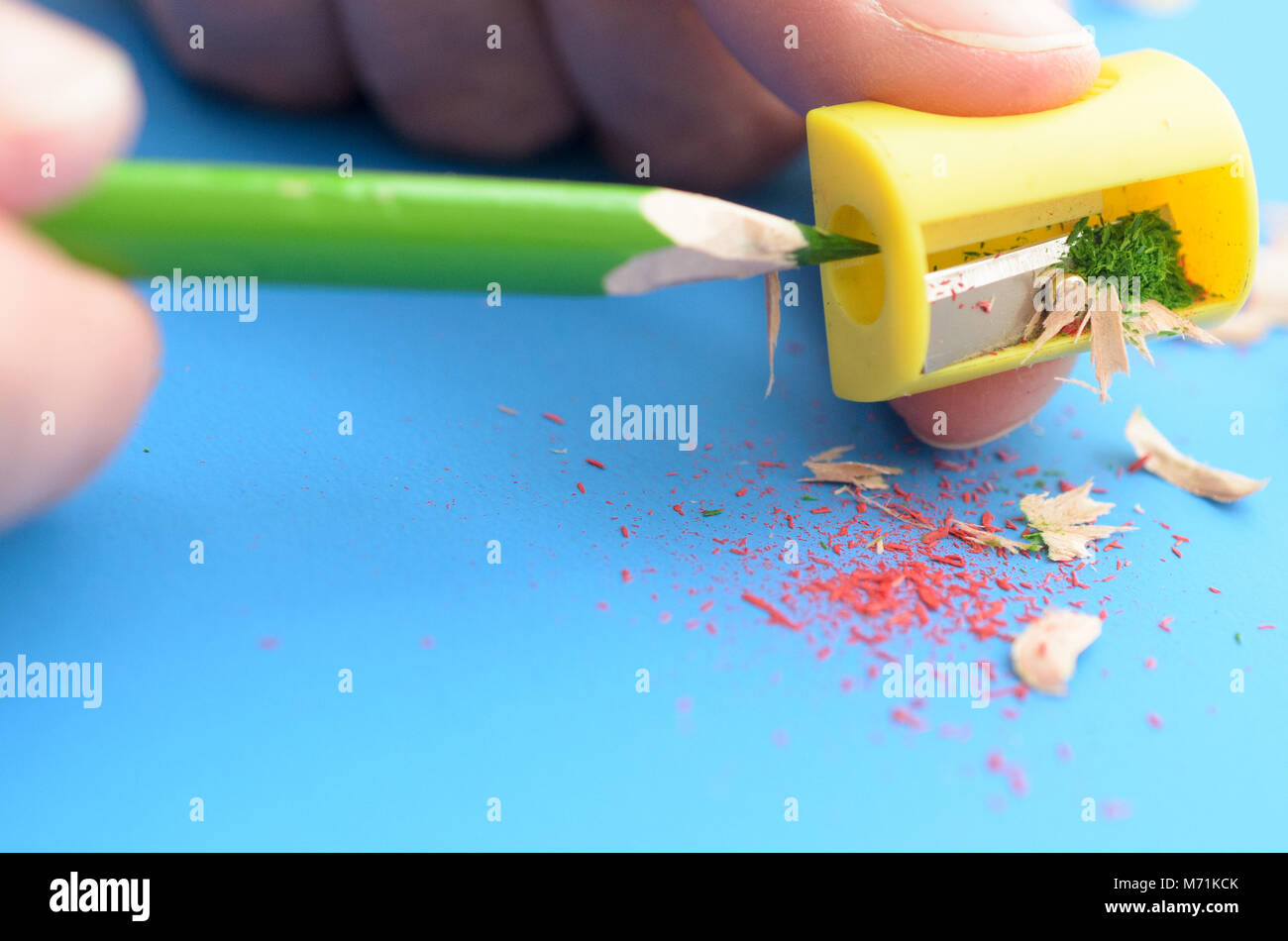 Sharpen the colored pencils with a sharpener Stock Photo Alamy