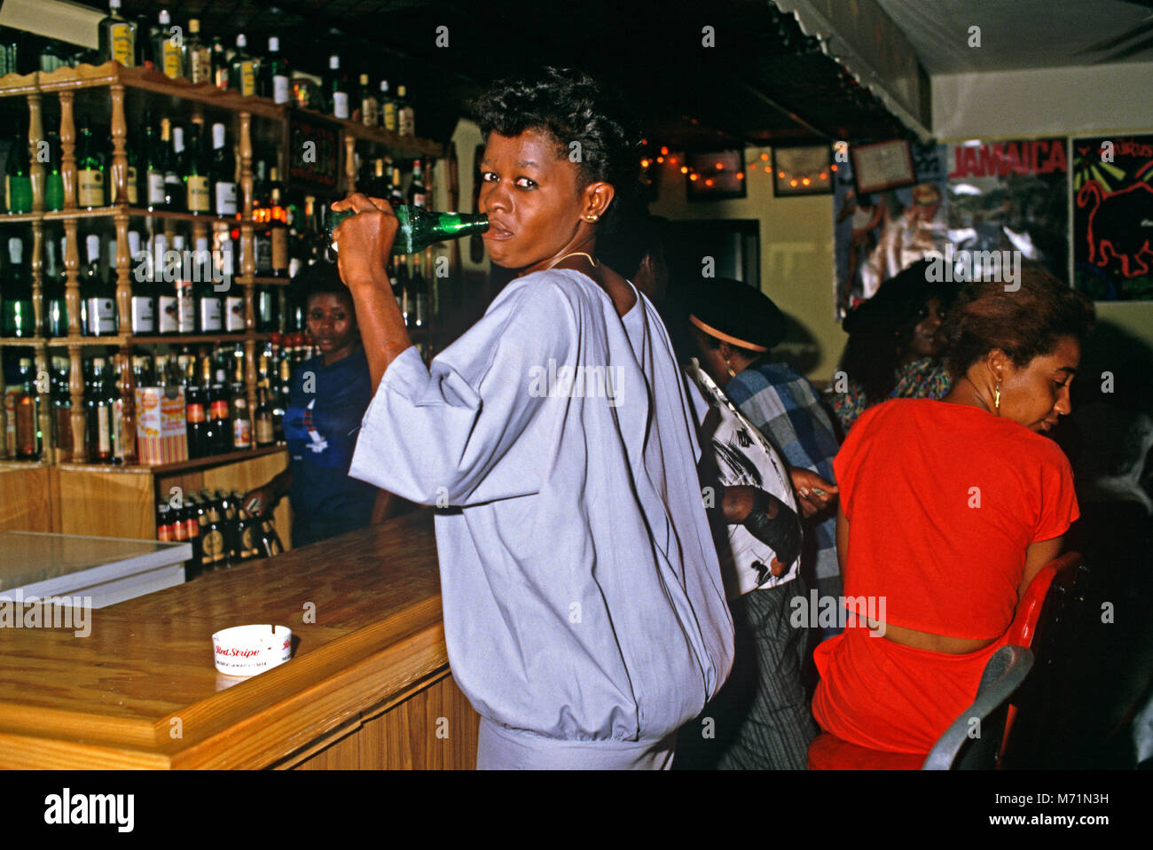 Girl drinking at Half Way Tree Bar, Kingston, Jamaica Stock Photo - Alamy