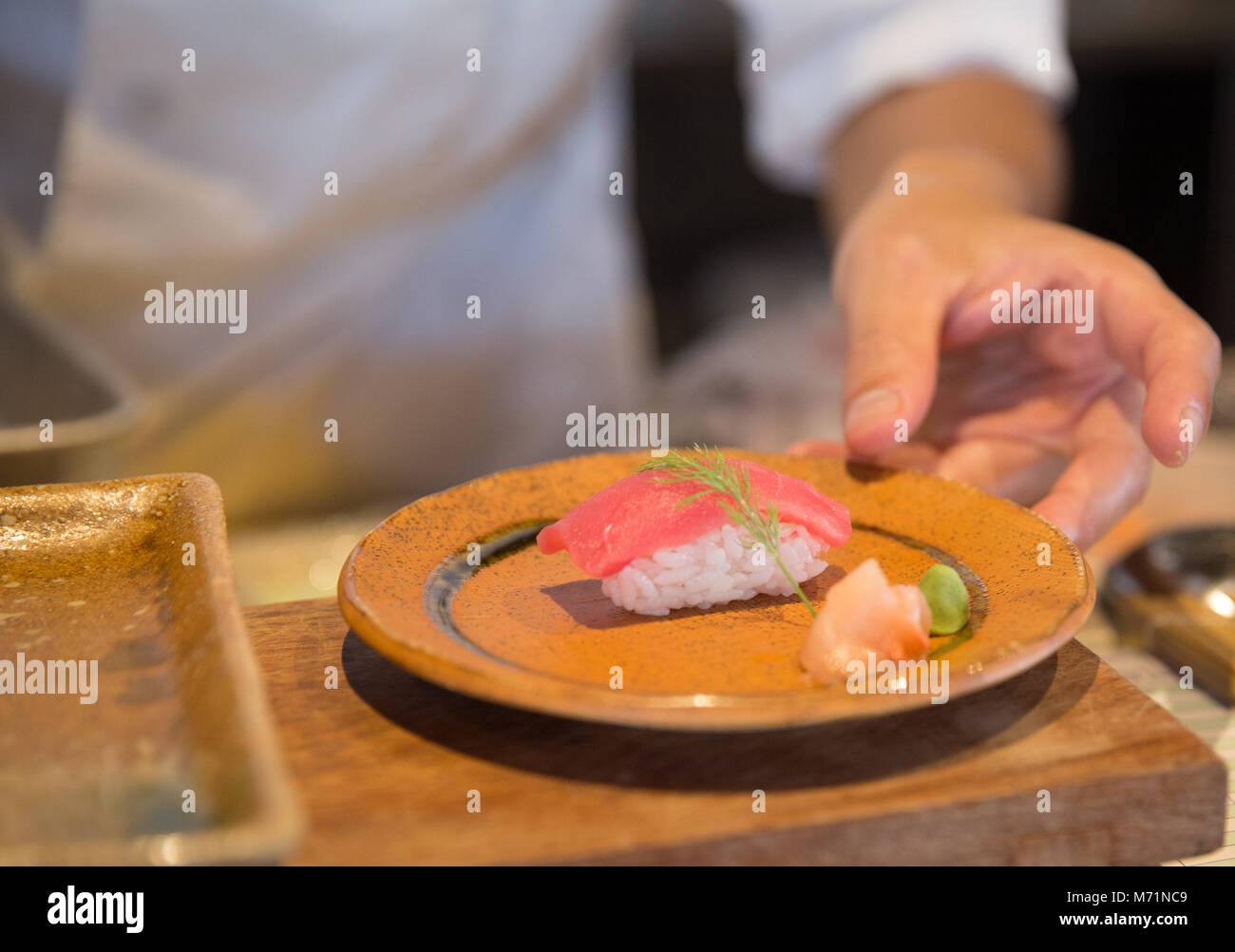 Freshly made tuna sushi served by the chef Stock Photo