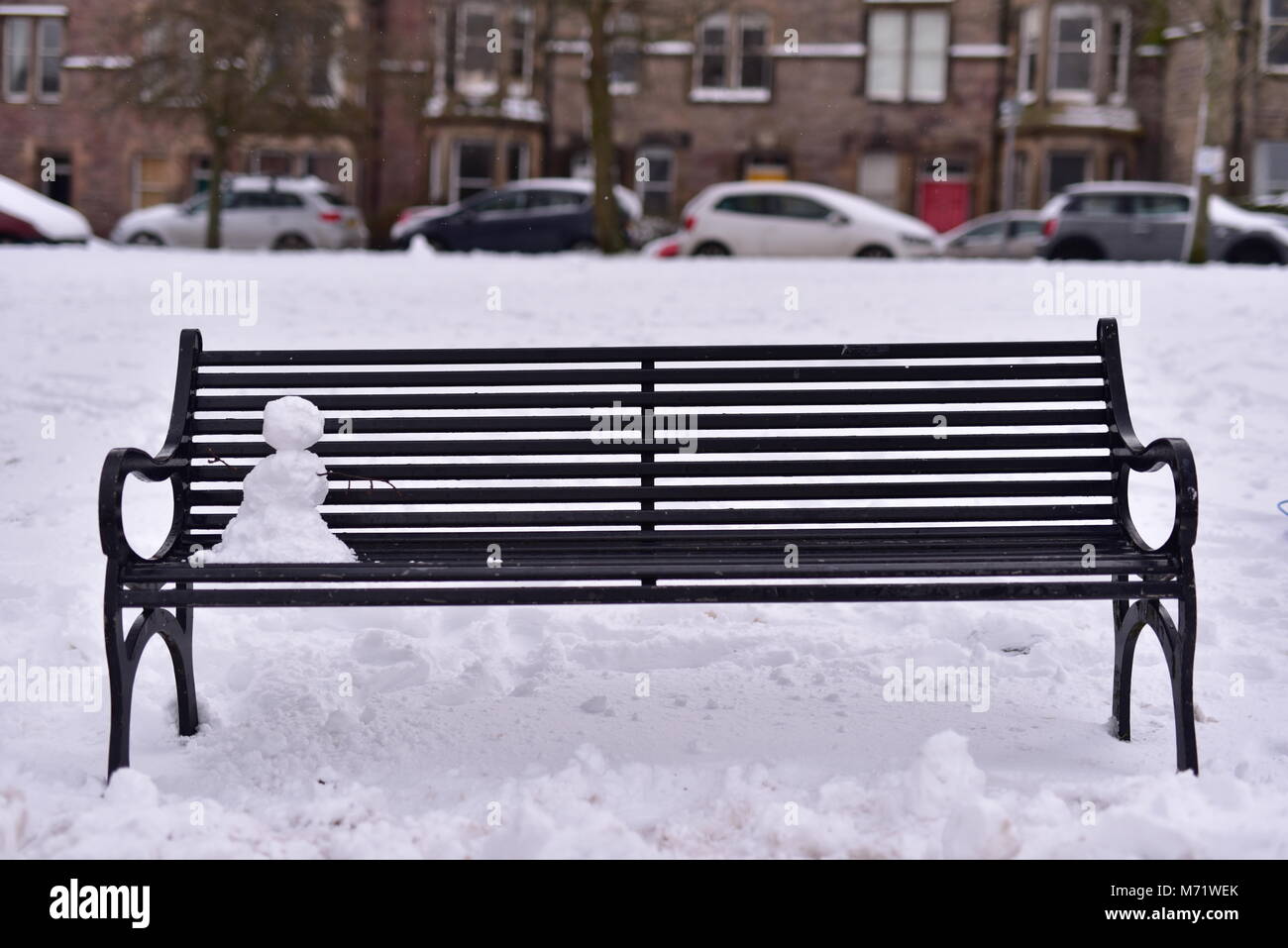 Lonely snowman sitting on a park bench Stock Photo - Alamy