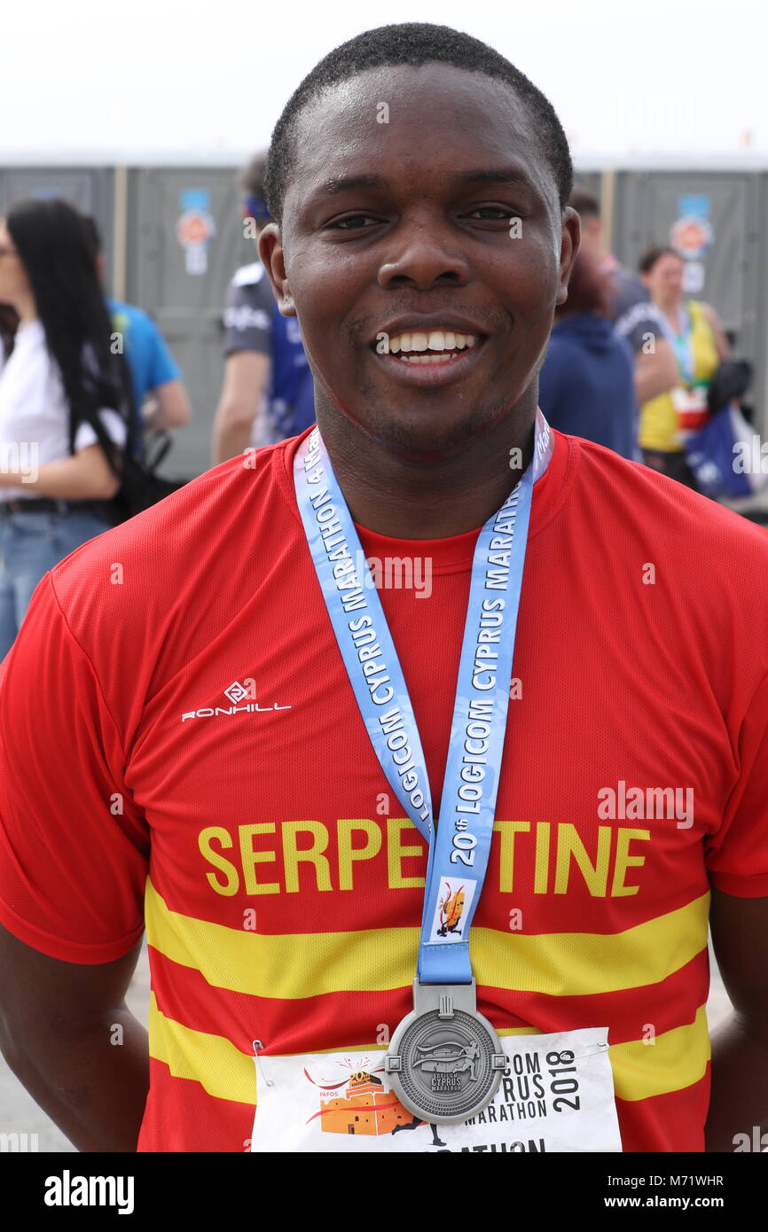 Black man with his medal at the 20th Logicom Cyprus marathon, half marathon, 10KM, 5KM fun run for international competitors in Paphos, Cyprus, Europe Stock Photo