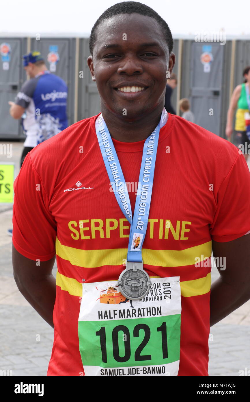 Black man with his medal at the 20th Logicom Cyprus marathon, half marathon, 10KM, 5KM fun run for international competitors in Paphos, Cyprus, Europe Stock Photo