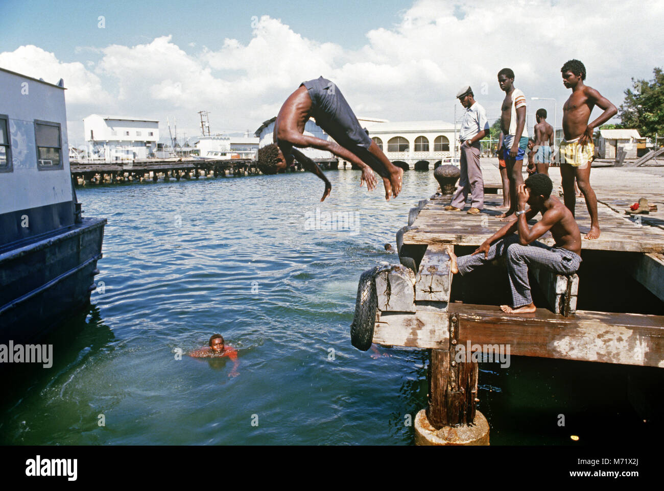 Jamaican kids swimming and diving in Kingston harbour, jamaica Stock