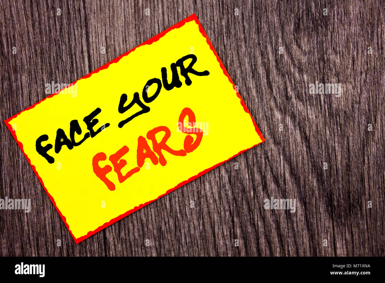 Conceptual hand writing text showing Face Your Fears. Concept meaning Challenge Fear Fourage Confidence Brave Bravery written Yellow Sticky Note Paper Stock Photo