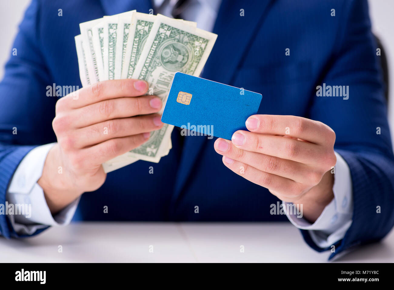 Businessman holding dollar money and credit card Stock Photo - Alamy