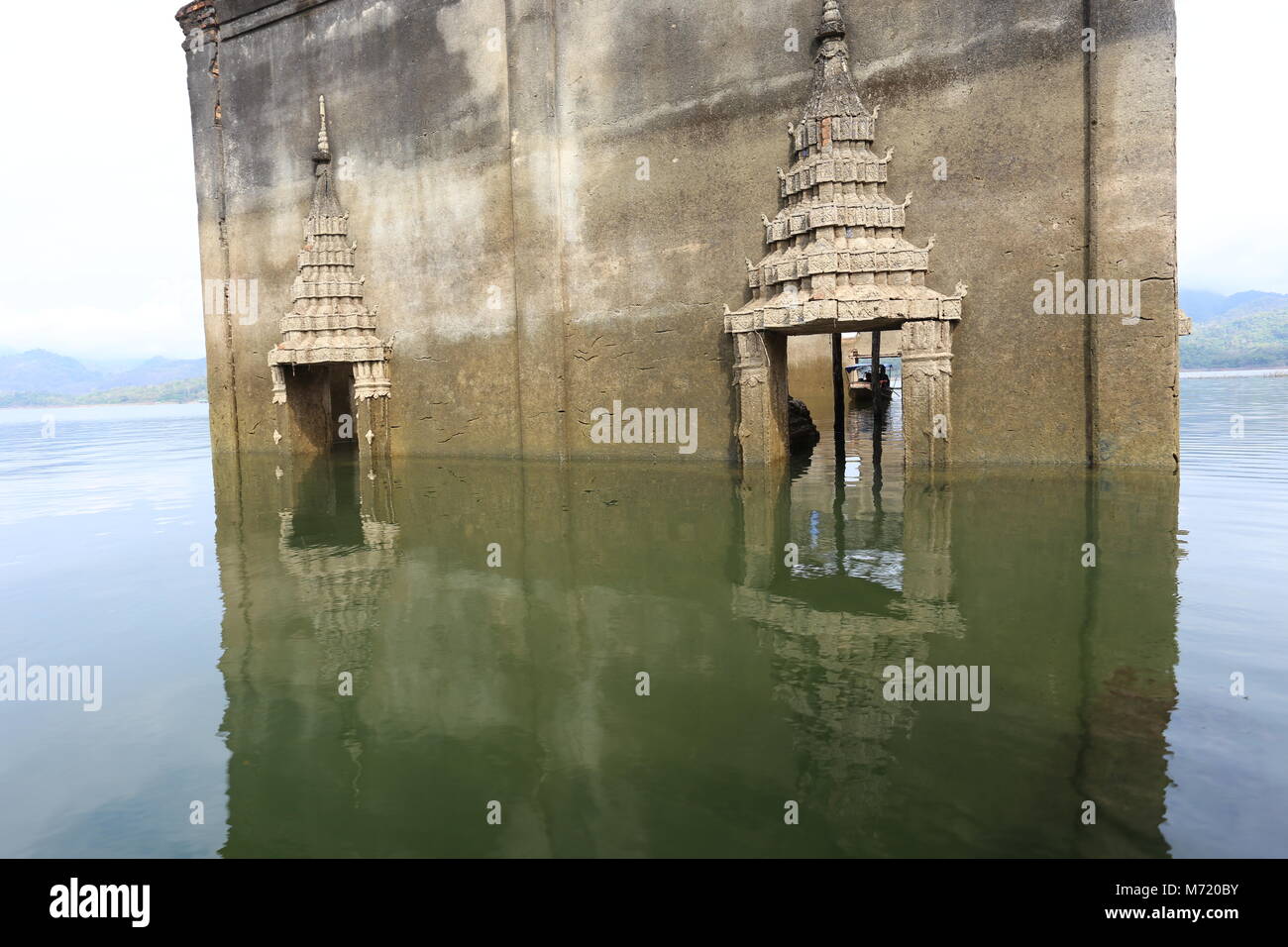 The Sunken Temple, Wat Saam Prasob, is the only remaining structure in this village purposely flooded after construction of the Khao Lem Dam. Stock Photo