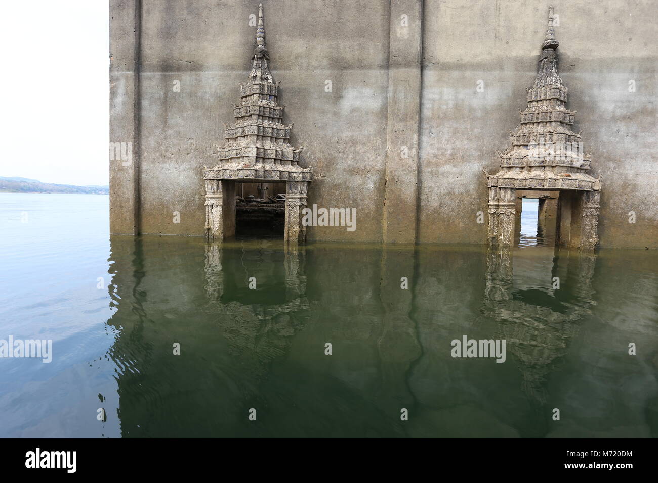 The Sunken Temple, Wat Saam Prasob, is the only remaining structure in this village purposely flooded after construction of the Khao Lem Dam. Stock Photo