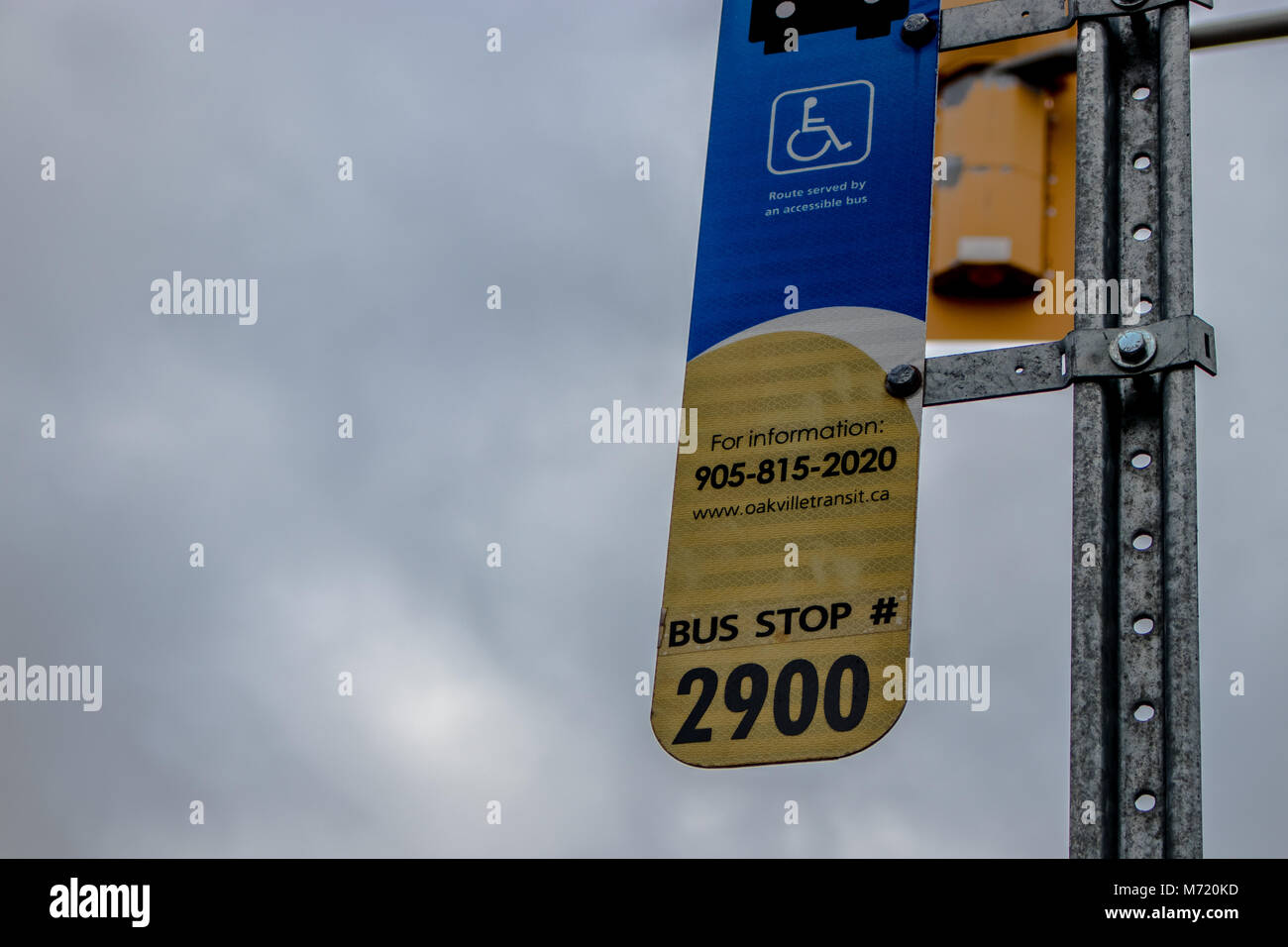 An Oakville Transit bus stop sign along sixth line Stock Photo