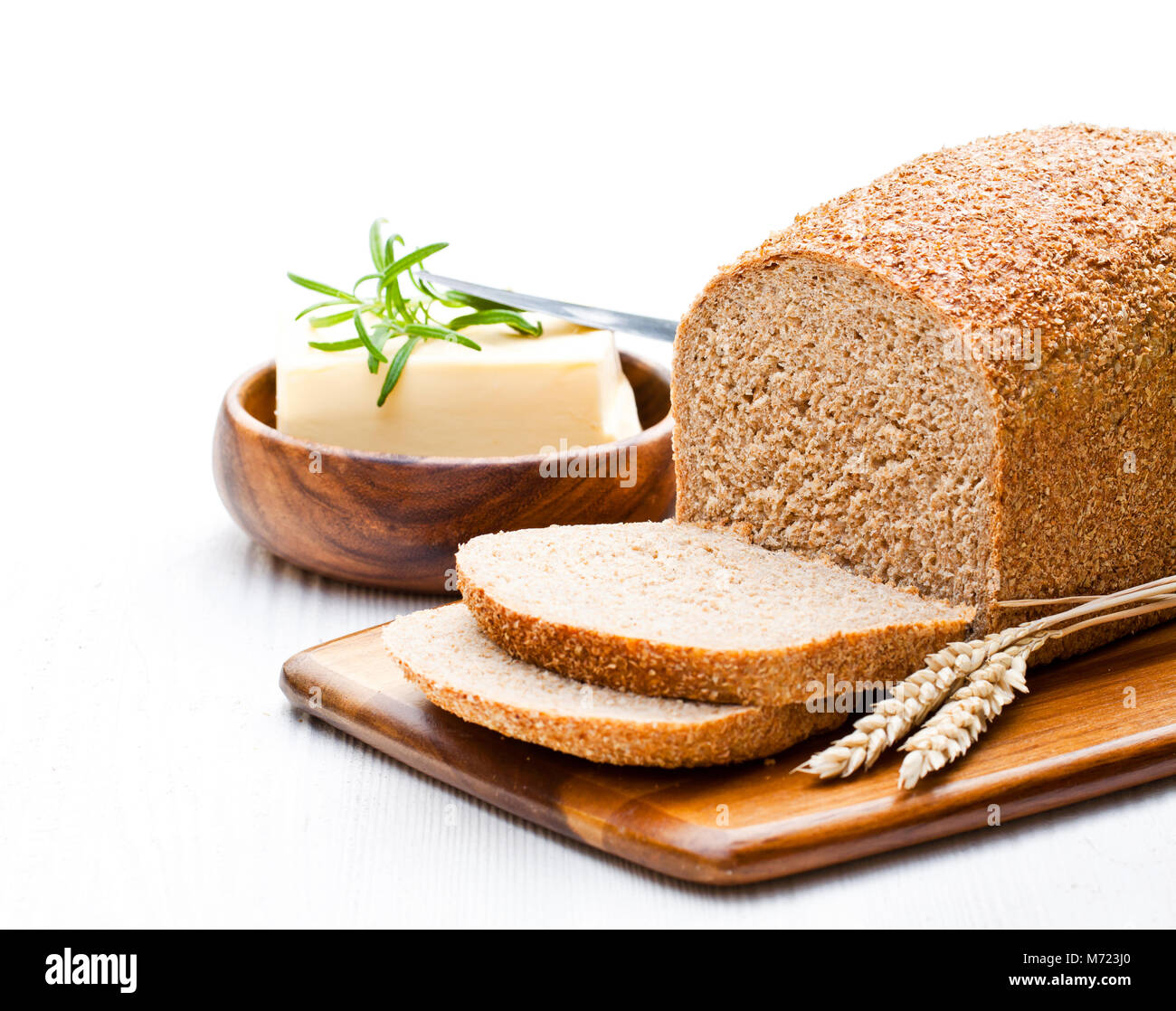 Sliced slowbaked organic wholemeal bread with butter and rosemary and