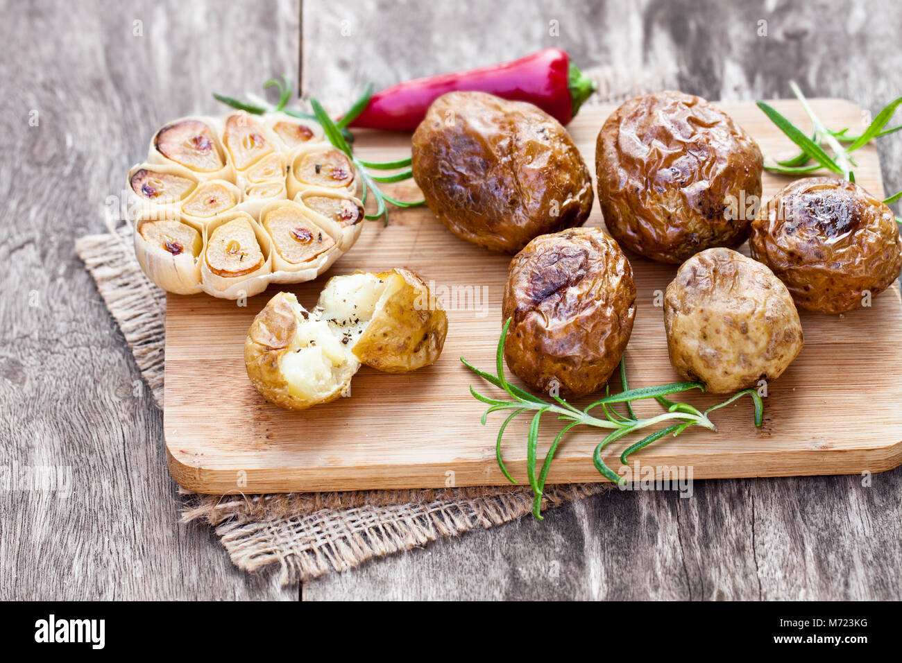 Delicious  baked potato and garlic with chillie and rosemary Stock Photo