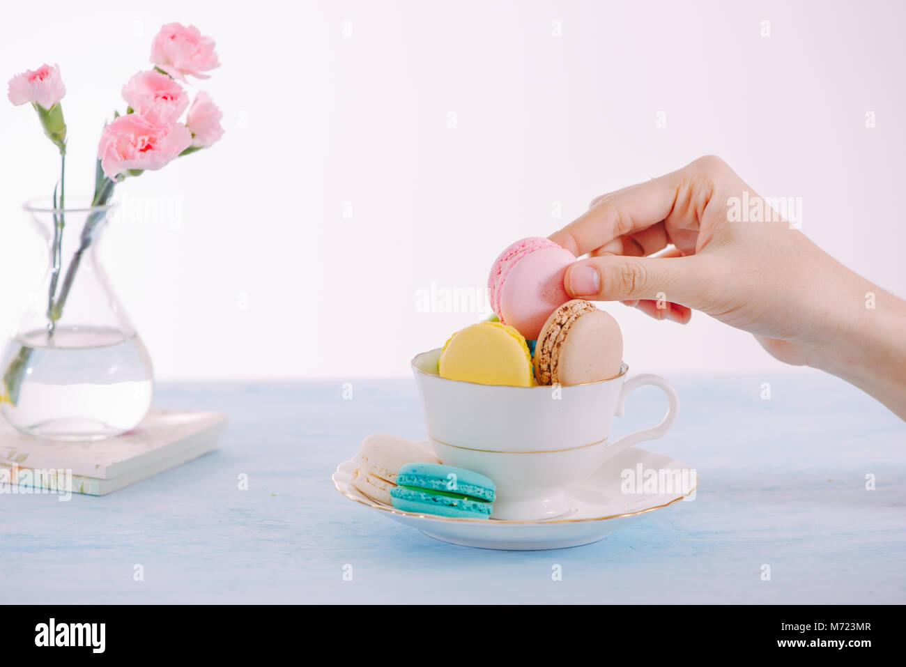 Sweet dessert. Colorful macarons on table in morning. Stock Photo