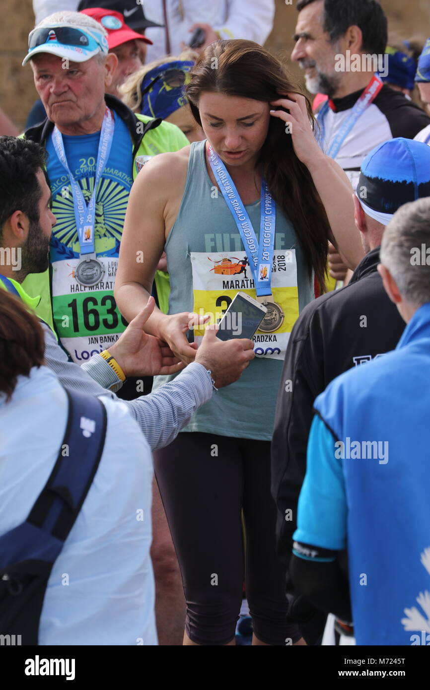 Competitor with medal after the 20th Logicom Cyprus marathon, half marathon, 10KM, 5KM fun run, Paphos harbour near Paphos fort, Cyprus, Europe Stock Photo