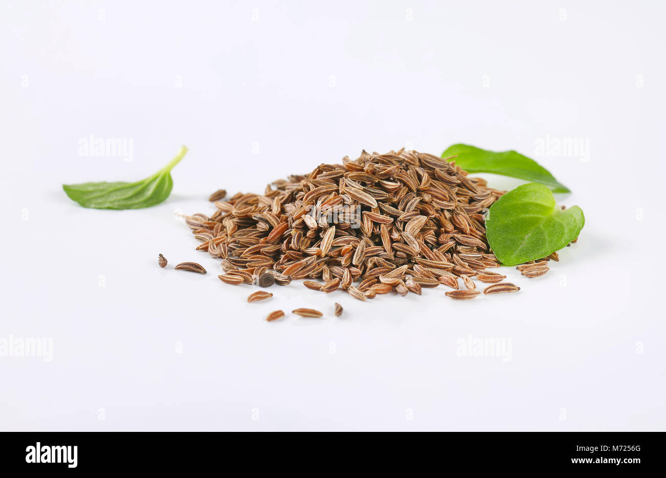 handful of caraway seeds on white background Stock Photo - Alamy